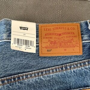 Levi's light blue denim jeans with tan leather patch